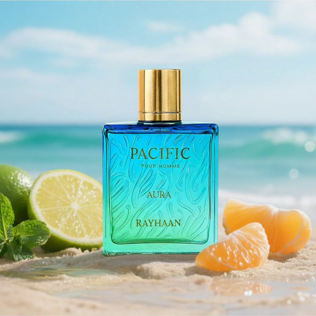 Blue perfume bottle with gold cap on a beach with lemons and oranges